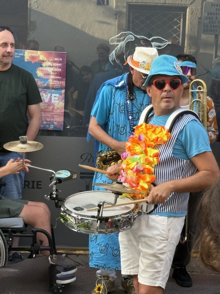 Street band performer playing drums.