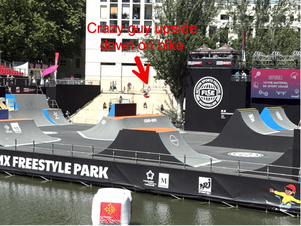 Picture of BMX bike event in progress with bike rider and bike upside down. Caption reads "Crazy guy updside down on bike" with arrow to bike.
